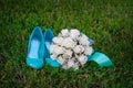 Turquoise shoes bride and white wedding bouquet on the grass Royalty Free Stock Photo