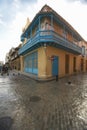 Turquoise shutters on a historic landmark building and cobblestone street in Old Havana, Cuba