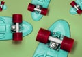 Turquoise Skateboards on green background, top view. Concept of sport lifestyle, culture, leisure, hobby, alternative transport Royalty Free Stock Photo