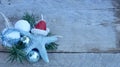 Christmas starfish, pine and bulbs on a rustic wood background