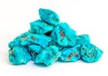 Turquoise stones heap on white. Good quality, very good colored rough turquoise stones. Using for its peaceful energy and for its