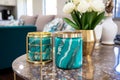 Turquoise vase with intricate golden patterns on dark marble table. detailed close-up