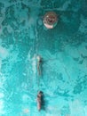 Turquoise wall with a light bulb and a voodoo doll