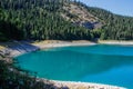 Turquoise water of the lake, pine forest and mountains. Stunning background with nature