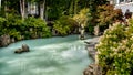 The turquoise water of the Pond in Village Park on the Village Stroll at the Olympic Plaza in the Village of Whistler Royalty Free Stock Photo