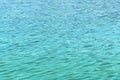 Turquoise water with small waves background, texture