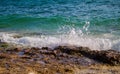 Turquoise water of tropical sea. Waves and stones near coastline. Oceanic landscape.