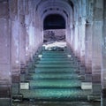 turquoise water under stone archways aqueduct