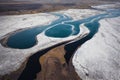 Turquoise water and white snow on Iceland aerial river