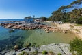 Turquoise waters rippled, lichen growing on granite rocks, rocky Royalty Free Stock Photo