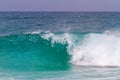 Turquoise wave breaks up to the shore