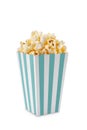 Turquoise white striped carton bucket with tasty cheese popcorn, isolated on white background