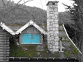Turquoise window on old green moss roof Royalty Free Stock Photo