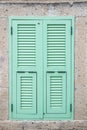 Turquoise window shutter on stone wall Royalty Free Stock Photo