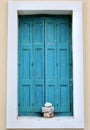 Turquoise window with stone decorations in Greece