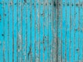 Turquoise wooden plank wall with peeling paint