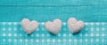 Turquoise wooden shabby chic background with white hearts on a c