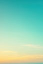 Turquoise and yellow gradient sky with clouds forming at sunset Royalty Free Stock Photo