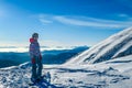 Turrach - A girl standing on top of the mountain with her snowboard