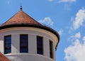 Turret type circular building top with sloped brown clay tile roof