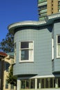 Turret or spire style building room with blue wooden exterior facade with white accent frames in modern downtown city