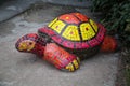 Turtle figurine, made of mosaic red yellow. The design of the city Park