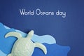 Turtle and paper cut for world oceans day. Save the oceans papercut on blue sea water background. Environment care and nature prot