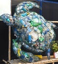 turtle-shaped trash can full of plastic bottles and cans as a propaganda of ecology