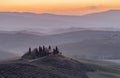 The Tuscan countryside in the province of Siena shrouded in morning mist before the dawn of a new day Royalty Free Stock Photo