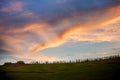 Tuscan hill with row of cypress trees and farmhouse ruin at sunset. Tuscan landscape. Italy Royalty Free Stock Photo