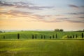 Tuscan hill with row of cypress trees and farmhouse ruin at sunset. Tuscan landscape. Tuscany, Italy Royalty Free Stock Photo