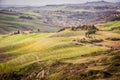 Tuscan hill with row of cypress trees and farmhouse at sunset. Tuscan landscape. Italy Royalty Free Stock Photo