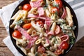 Tuscan salad of penne pasta with salami, and vegetables with cream sauce close-up. horizontal top view Royalty Free Stock Photo