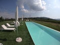 Tuscan wine estate with blue infinity pool in the vineyards travel