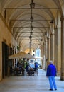 TUSCANY, AREZZO. tourists relaxing on outdoor restaurant tables in the Piazza grande under Vasari loggias Loggia di Va