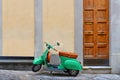 TUSCANY, AREZZO. Vintage green Vespa Piaggio scooter in old narrow street in historical center of Arezzo