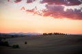 Tuscany landscape with cypress trees, hills and farms at sunset Royalty Free Stock Photo