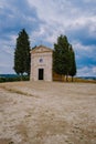 Tuscany landscape with grain fields, cypress trees and houses on the hills at sunset. Summer rural landscape with curved Royalty Free Stock Photo