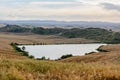 Tuscany landscape of a lake and soft hills