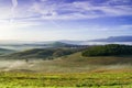 Tuscany landscape with rolling hills and valleys in golden morning light Royalty Free Stock Photo