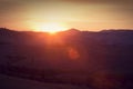 Tuscany landscape at sunrise, Italy. Tuscan hills, sun flare