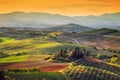 Tuscany landscape at sunrise. Tuscan farm house, vineyard, hills.