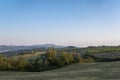 Tuscany, rural landscape in Crete Senesi land. Rolling hills, countryside farm, cypresses trees, green field on warm sunset. Siena Royalty Free Stock Photo