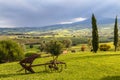 Tuscany rural landscape with old plow in the foreground. Toscana in the morning, Italy. Royalty Free Stock Photo