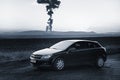 Tusimice, Czech republic - February 14, 2018: black car Opel Astra between fields in winter with Krusne hory mountains and coal po