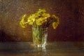 Tussilago bouquet in glass in water drops and sunshine