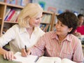 Tutor assisting mature student in library