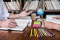 Tutor books with friends, Young students campus or classmates helps friend catching up workbook and learning tutoring in classroom Royalty Free Stock Photo