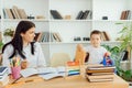 Tutor deals with the preschooler with a laptop, a real home interior, the concept of childhood and learning