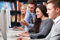 Tutor Helping Teenage Students Working At Computers Royalty Free Stock Photo